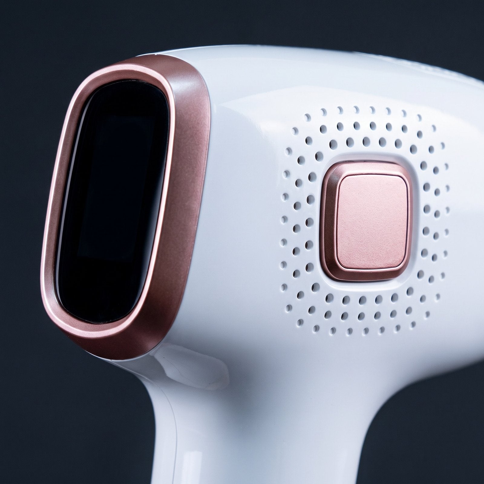 Macro of the Pearl 01 control face, its rose-gold button set in a field of perforated vents